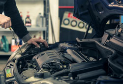 Mechanic working on engine of car